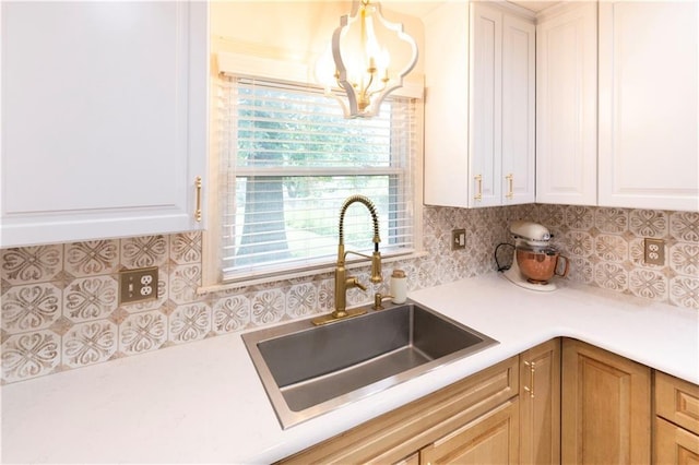 12408 Monroe Ave, Grandview, MO 64030 - kitchen featuring a chandelier, tasteful backsplash, light countertops, and white cabinetry