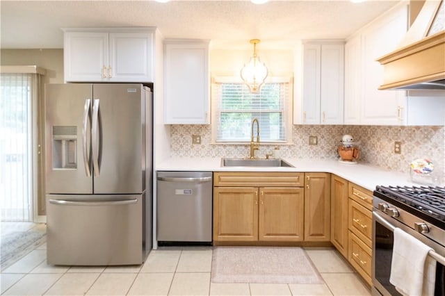 12408 Monroe Ave, Grandview, MO 64030 - kitchen with stainless steel appliances, custom exhaust hood, a chandelier, backsplash, and light countertops