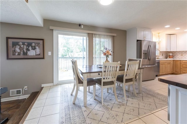 12408 Monroe Ave, Grandview, MO 64030 - dining space with light tile patterned flooring, a textured ceiling, and recessed lighting
