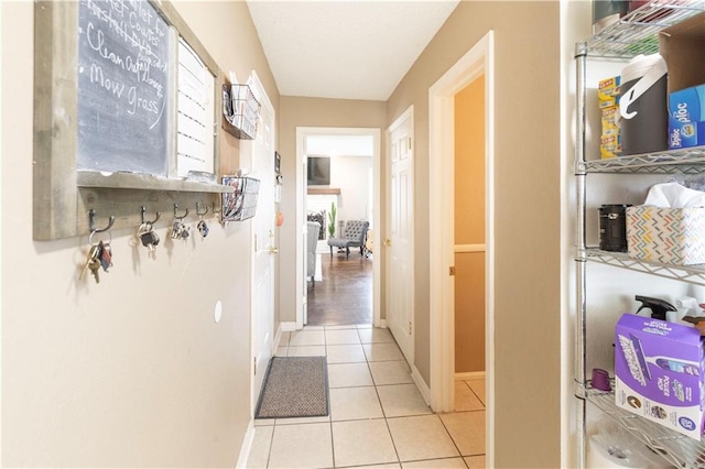 12408 Monroe Ave, Grandview, MO 64030 - hall with tile patterned floors and baseboards