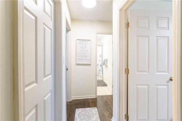 12408 Monroe Ave, Grandview, MO 64030 - hall with dark wood-style flooring and baseboards