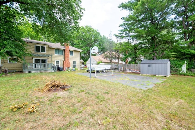 12408 Monroe Ave, Grandview, MO 64030 - view of yard featuring a storage unit and a wooden deck