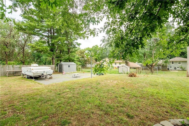 12408 Monroe Ave, Grandview, MO 64030 - fenced backyard with a shed and a patio