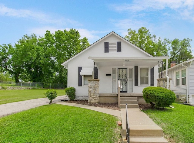 2527 N 18th St, Kansas City, KS 66104 - bungalow-style home featuring covered porch and stucco siding