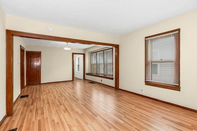 2527 N 18th St, Kansas City, KS 66104 - spare room with light wood-style flooring, a textured ceiling, and a smoke detector