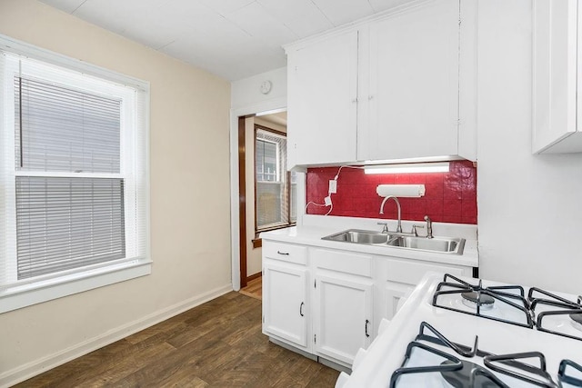 2527 N 18th St, Kansas City, KS 66104 - kitchen with light countertops, tasteful backsplash, white cabinets, and dark wood-type flooring