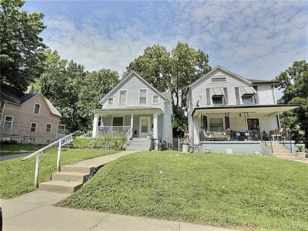 2006 Agnes Ave, Kansas City, MO 64127 - view of front of home featuring covered porch, stairs, and a front yard
