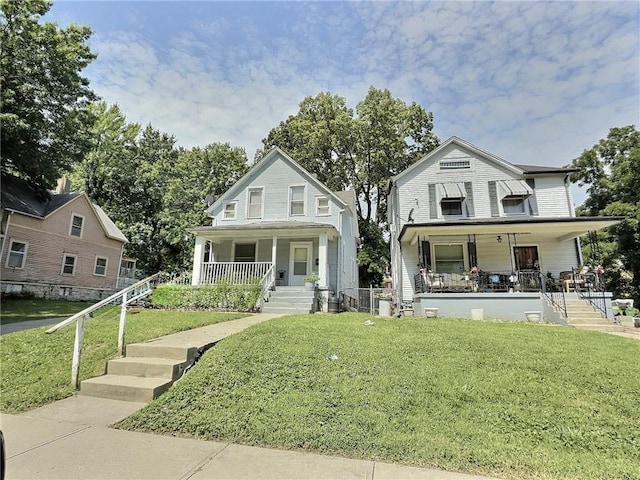 2006 Agnes Ave, Kansas City, MO 64127 - view of front of home featuring covered porch, stairs, and a front yard