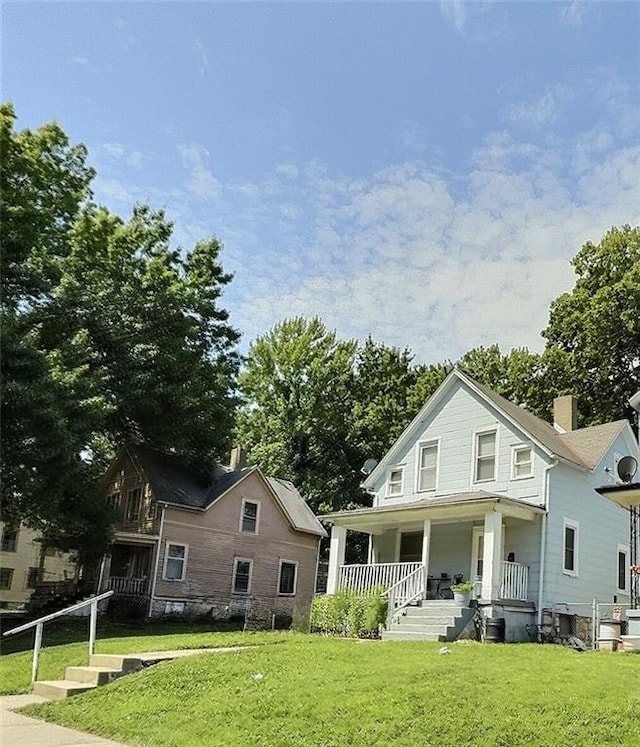 2006 Agnes Ave, Kansas City, MO 64127 - rear view of property with a porch and a yard