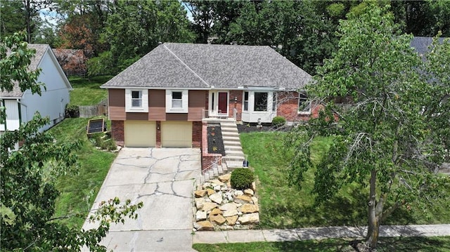 5300 NW 58th Ter, Kansas City, MO 64151 - view of front of house featuring brick siding, concrete driveway, a shingled roof, and a garage