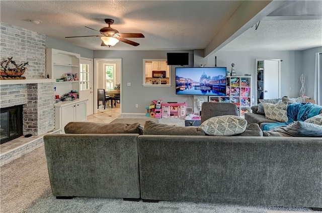 5300 NW 58th Ter, Kansas City, MO 64151 - carpeted living area featuring a textured ceiling, ceiling fan, and a fireplace