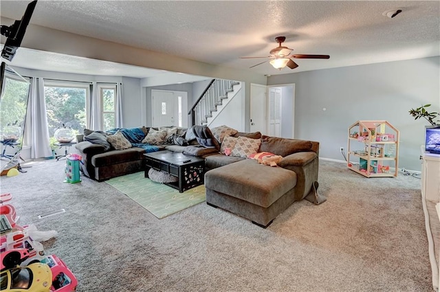 5300 NW 58th Ter, Kansas City, MO 64151 - living room featuring carpet, stairway, a textured ceiling, and a ceiling fan