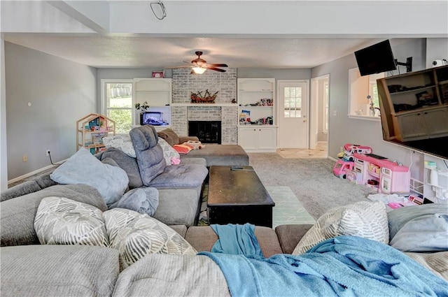 5300 NW 58th Ter, Kansas City, MO 64151 - living room featuring a ceiling fan, carpet, and a brick fireplace