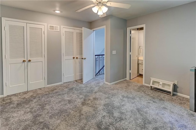 5300 NW 58th Ter, Kansas City, MO 64151 - unfurnished bedroom featuring multiple closets, carpet, and ceiling fan