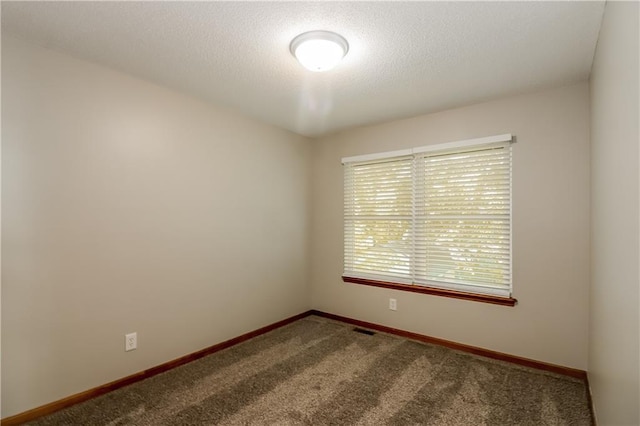 704 Canter St, Raymore, MO 64083 - spare room featuring carpet and a textured ceiling