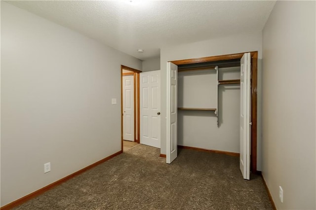 704 Canter St, Raymore, MO 64083 - unfurnished bedroom featuring carpet, a closet, and a textured ceiling
