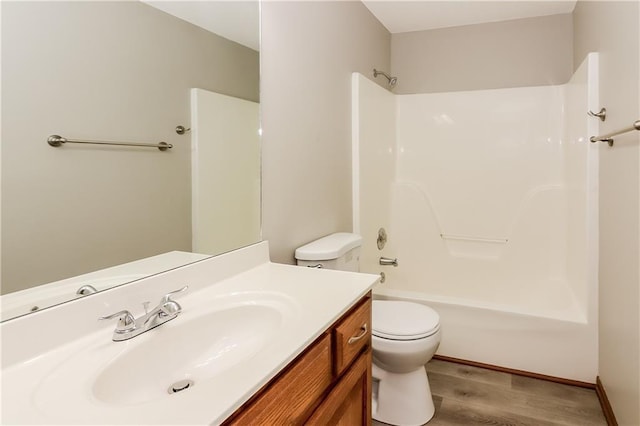 704 Canter St, Raymore, MO 64083 - bathroom featuring wood finished floors, vanity, and bathtub / shower combination