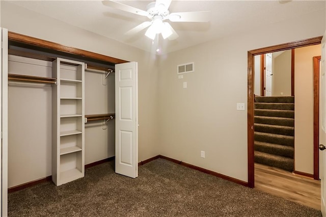 704 Canter St, Raymore, MO 64083 - unfurnished bedroom featuring dark carpet, a ceiling fan, and a closet