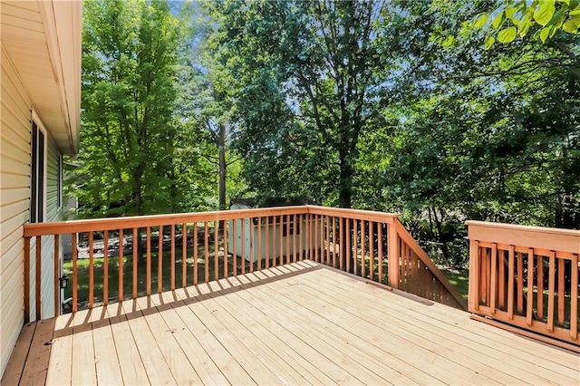 704 Canter St, Raymore, MO 64083 - wooden deck featuring view of wooded area