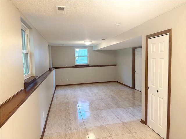 704 Canter St, Raymore, MO 64083 - spare room featuring a textured ceiling and light tile patterned flooring