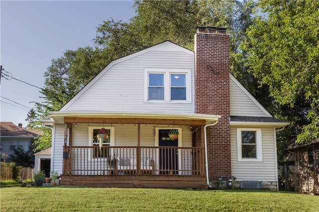 2026 E 70th Ter, Kansas City, MO 64132 - view of front of property featuring covered porch, a chimney, and a front lawn
