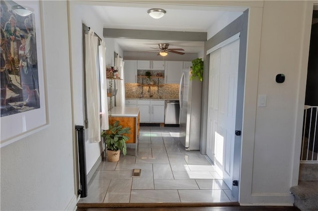 2026 E 70th Ter, Kansas City, MO 64132 - hall with light tile patterned floors and baseboards