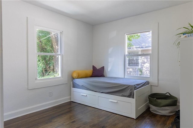 2026 E 70th Ter, Kansas City, MO 64132 - bedroom with multiple windows and dark wood-style flooring