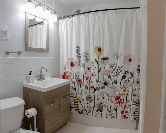 2026 E 70th Ter, Kansas City, MO 64132 - full bath with tile walls, vanity, and a shower with shower curtain