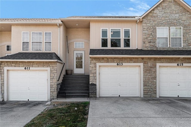 613 S Woodson Ln, Gardner, KS 66030 - view of front of home featuring stone siding, driveway, and a garage