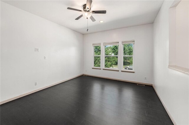 613 S Woodson Ln, Gardner, KS 66030 - unfurnished room featuring ceiling fan and dark wood-type flooring