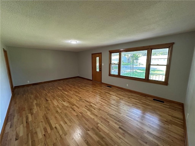 533 Utah St, Leavenworth, KS 66048 - empty room featuring wood finished floors and a textured ceiling