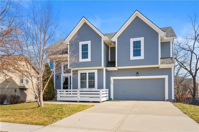 4603 N 111th St, Kansas City, KS 66109 - view of front facade with driveway, a garage, and a front lawn