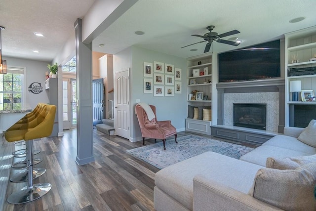 4603 N 111th St, Kansas City, KS 66109 - living room featuring wood finished floors, a ceiling fan, a glass covered fireplace, built in shelves, and recessed lighting