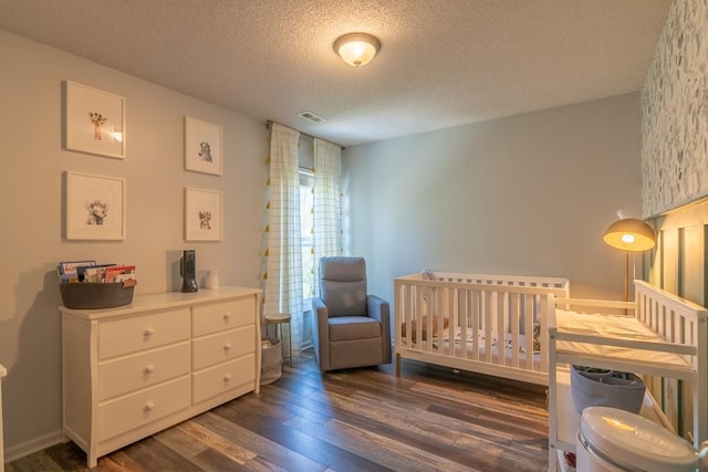 4603 N 111th St, Kansas City, KS 66109 - bedroom with wood finished floors, a textured ceiling, and a nursery area