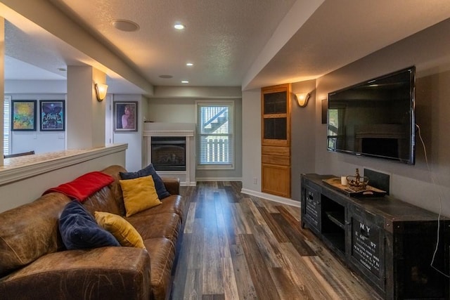 4603 N 111th St, Kansas City, KS 66109 - living area featuring recessed lighting, dark wood-style flooring, a fireplace, and a textured ceiling