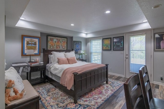 4603 N 111th St, Kansas City, KS 66109 - bedroom with a tray ceiling, access to exterior, wood finished floors, and recessed lighting