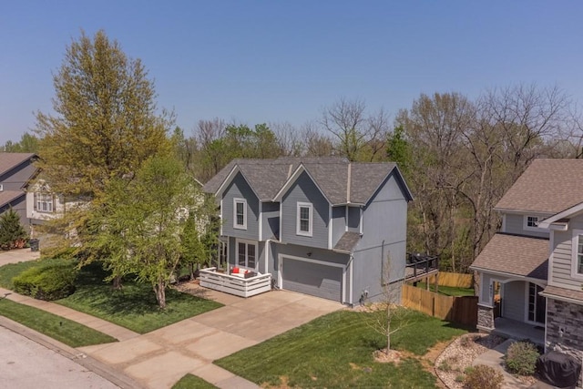 4603 N 111th St, Kansas City, KS 66109 - view of front of home with concrete driveway, an attached garage, and a shingled roof