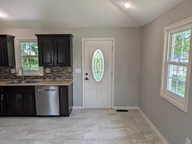 2205 S Owing St, Oak Grove, MO 64075 - kitchen featuring dishwasher, plenty of natural light, decorative backsplash, lofted ceiling, and light stone counters