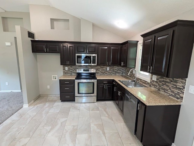 2205 S Owing St, Oak Grove, MO 64075 - kitchen with stainless steel appliances, lofted ceiling, tasteful backsplash, light marble finish flooring, and light stone countertops