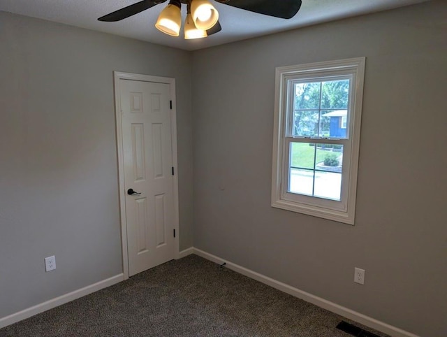 2205 S Owing St, Oak Grove, MO 64075 - spare room featuring a ceiling fan and dark carpet