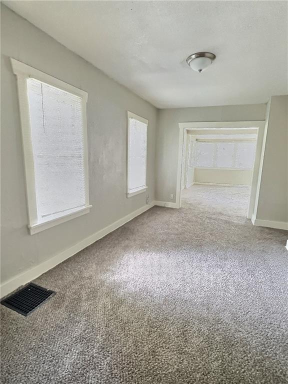 8409 Park Ave, Kansas City, MO 64132 - empty room featuring carpet flooring