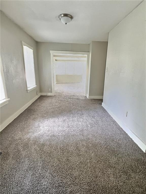 8409 Park Ave, Kansas City, MO 64132 - unfurnished room with baseboards and carpet floors