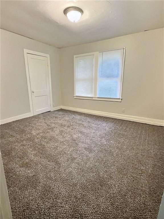 8409 Park Ave, Kansas City, MO 64132 - carpeted empty room with baseboards