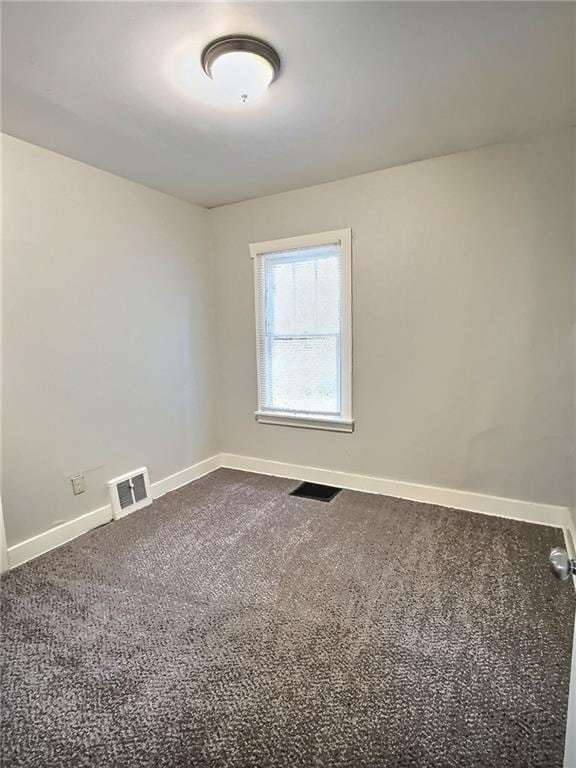 8409 Park Ave, Kansas City, MO 64132 - unfurnished room with baseboards and dark colored carpet