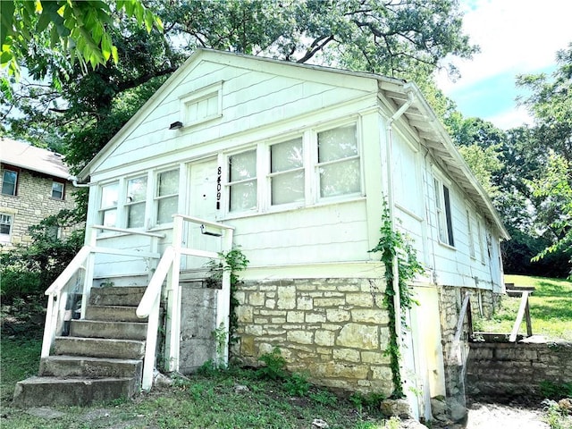 8409 Park Ave, Kansas City, MO 64132 - bungalow-style house with stone siding