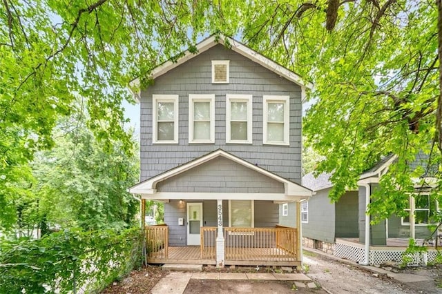 3543 Flora Ave, Kansas City, MO 64109 - view of front of property with covered porch and a sunroom