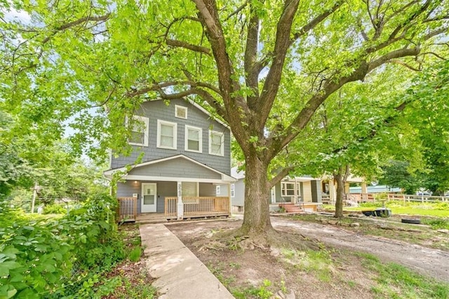 3543 Flora Ave, Kansas City, MO 64109 - american foursquare style home featuring a porch