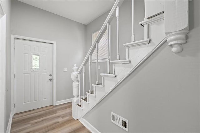 3543 Flora Ave, Kansas City, MO 64109 - entrance foyer featuring stairs and light wood finished floors