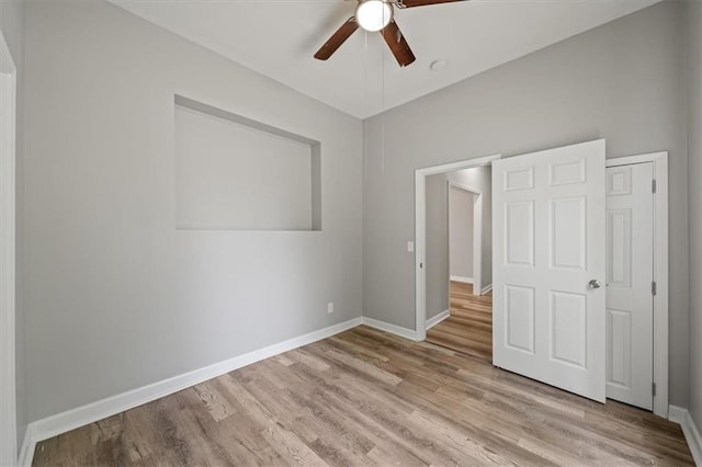 3543 Flora Ave, Kansas City, MO 64109 - unfurnished bedroom with wood finished floors and ceiling fan