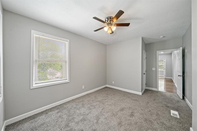 3543 Flora Ave, Kansas City, MO 64109 - unfurnished bedroom with carpet flooring, a textured ceiling, and ceiling fan